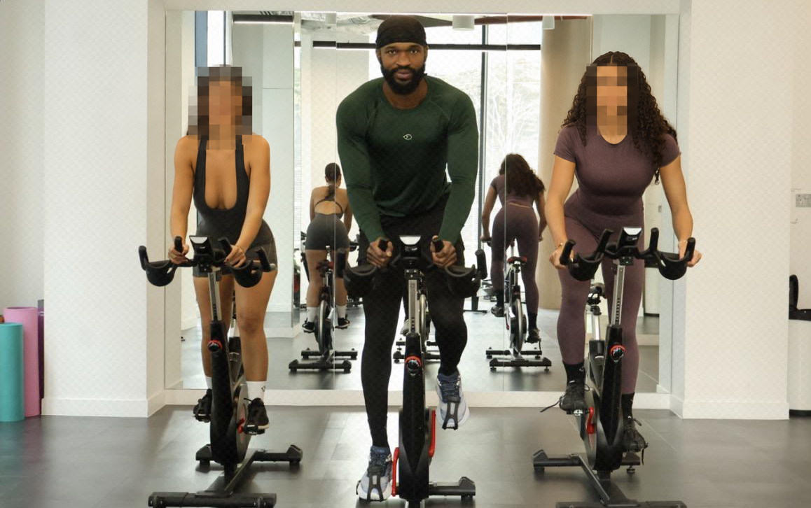 Haqq leading a spin class with other participants’ faces pixelated for privacy